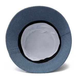 Detailed interior of a blue denim sun hat showing white fabric lining and black sweatband