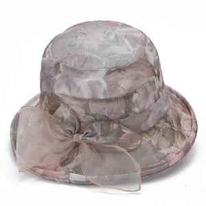Elegant wide brim sun hat for women with floral mesh patterns and bow decoration