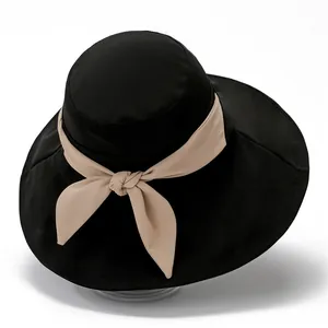 Women's wide brim sun hat in black with elegant beige ribbon bow for beach sun protection