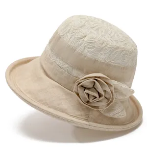 Beige sun hat for elderly women with elegant lace stitching and a fabric flower detail