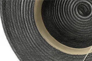 Detail view of woven straw sun hat interior with sweatband and spiral texture