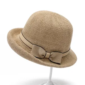 Elegant beige straw sun hat for elderly women with brown ribbon and bow decoration
