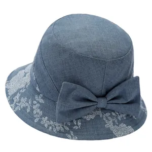 Elegant blue sun hat for women with a large bow and white floral patterns on the brim