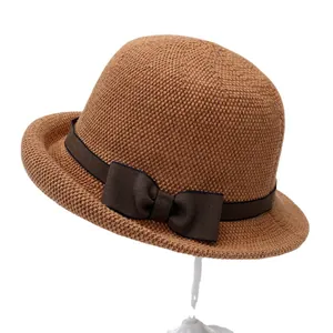 Classic straw sun hat for elderly women with brown ribbon bow on white background