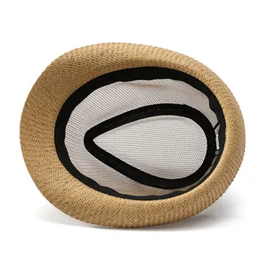 Detail of the woven straw hat interior featuring breathable mesh and a black sweatband