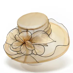 Detail of champagne organza sun hat featuring a large layered floral ornament with beads