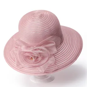 Detail of elegant pink organza sun hat with a large handmade floral mesh decoration