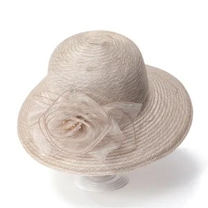 Detail of elegant beige sun hat featuring a large layered mesh flower with golden beads