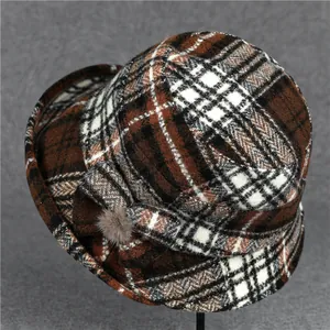 Classic plaid winter bucket hat for women with a side bow and cozy fur ball detail