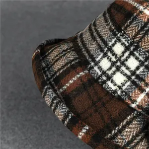 Detailed close-up of brown plaid wool bucket hat with thick textured weave and rolled brim