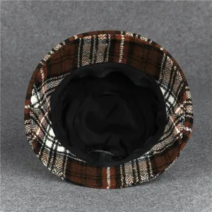 Detail view of winter bucket hat showing black inner lining and woven plaid texture