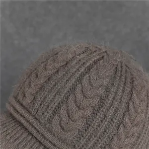 Detailed close-up of brown cable knit wool texture and thick plush fabric on an elderly woman hat