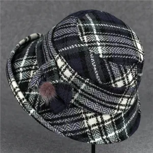 Plaid wool bucket hat for older women featuring a decorative bow and small pompom detail