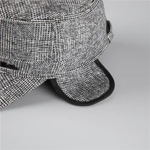Detail of the warm earflaps and vintage black and white checkered texture on the cadet cap