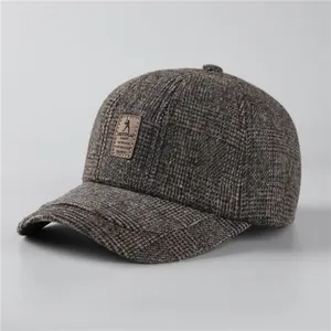 Mens winter baseball cap in brown grey plaid fabric with warm ear protection feature