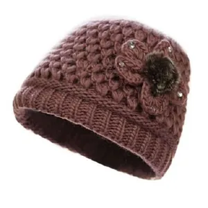 Women's warm winter knit hat in dusty rose with floral detail and plush faux fur ball