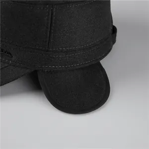 Detailed close-up of stitching on a warm black wool cadet cap with ear flaps for men