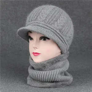 Detail of grey knitted winter hat and scarf set with thick cable pattern and warm fleece lining