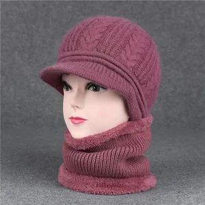 Detail of burgundy knit hat and scarf set with warm plush lining and thick cable pattern