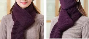 Detail of dark purple knitted winter scarf and face mask set with thick ribbed texture