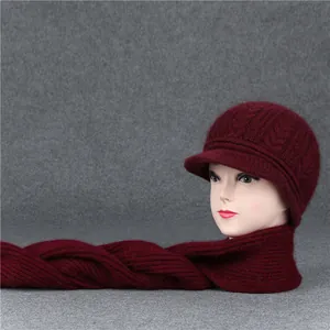 Detail of wine red knit hat and scarf set with cable pattern on mannequin head