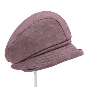 Detailed texture of dark red cotton linen hat with white geometric pattern and stitching
