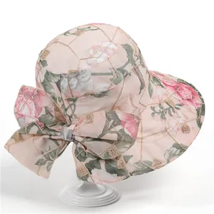 Women's pink floral wide brim sun hat with bow decoration and gold grid embroidery detail