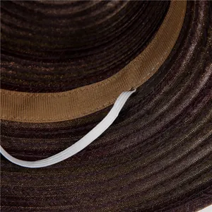 Detailed interior of woven sun hat showing adjustable chin strap and sweatband