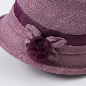 Close-up of lavender sun hat with mesh trim and handcrafted satin flower detail