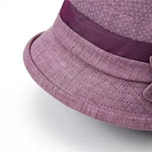 Close-up of linen-textured fabric and breathable mesh on a purple sun hat for women