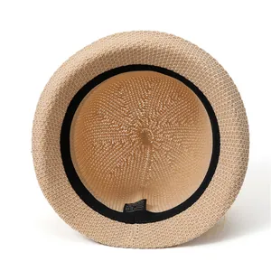 Close-up of woven straw hat interior showing the washing label and fabric composition