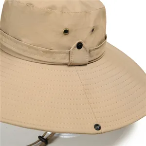 Detailed macro view of khaki sun hat with metallic vent holes and reinforced brim stitching