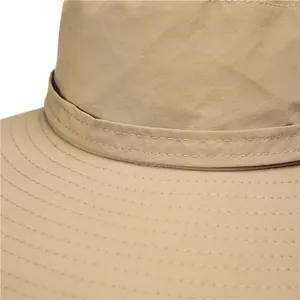 Close-up of khaki wide-brim sun hat showing durable stitching and quick-dry fabric texture