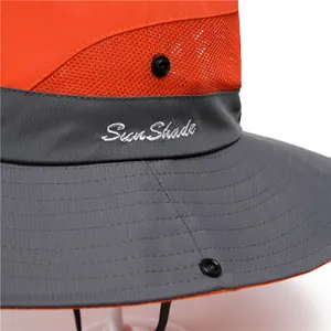 Dettaglio cappello parasole con rete arancione traspirante e ricamo Sun Shade