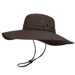 Detail of dark brown sun hat featuring a wide brim with adjustable windproof cord and vents