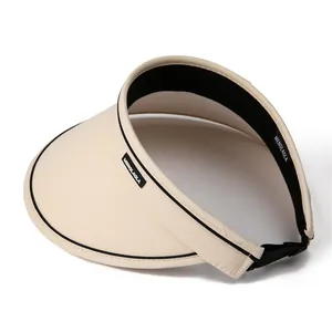 Beige UPF50+ wide brim empty top sun hat with adjustable strap and black trim detail