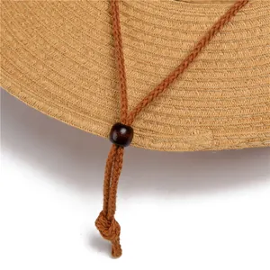 Detailed macro view of woven straw texture with adjustable wooden bead on chin strap