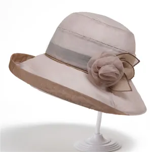 Elegant wide brim sun hat for women with mesh floral ribbon on display stand