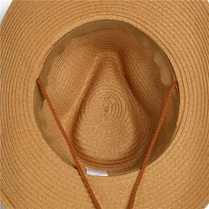 Detail shot of straw sun hat interior with sweatband and adjustable windproof rope cord