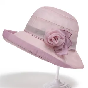 Elegant light pink sun hat for women with large organza flower and wavy brim detail