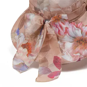 Detail of elegant organza sun hat with floral print and large decorative bow side