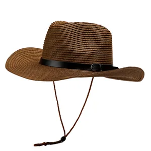 Macro view of brown woven straw cowboy hat with black leather strap and wind rope