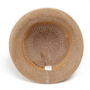 Detail of knitted sun hat interior showing the sweatband, drawstring, and material label