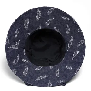 Detailed top view of a foldable dark blue sun hat with elegant white feather patterns