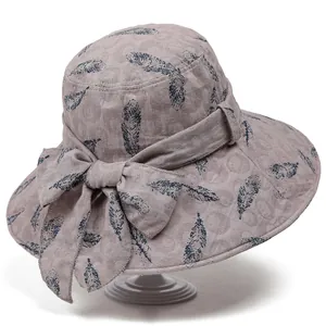 Foldable light grey sun hat with blue feather prints and a large side bow detail