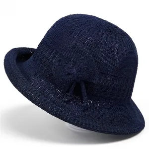 Women's navy knit bucket hat with stylish bow detail for sun protection in summer