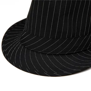 Detailed macro view of black fedora with fine white stripes and premium fabric texture