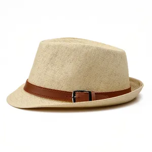 Detail of woven straw fedora hat featuring a brown leather band and metal buckle accent
