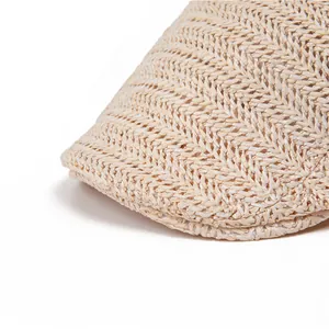 Detail shot of the beige breathable mesh weave and chevron pattern on the flat cap brim