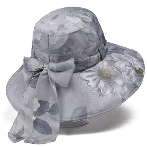 Detail of light blue sun hat with jacquard floral pattern and large decorative side bow